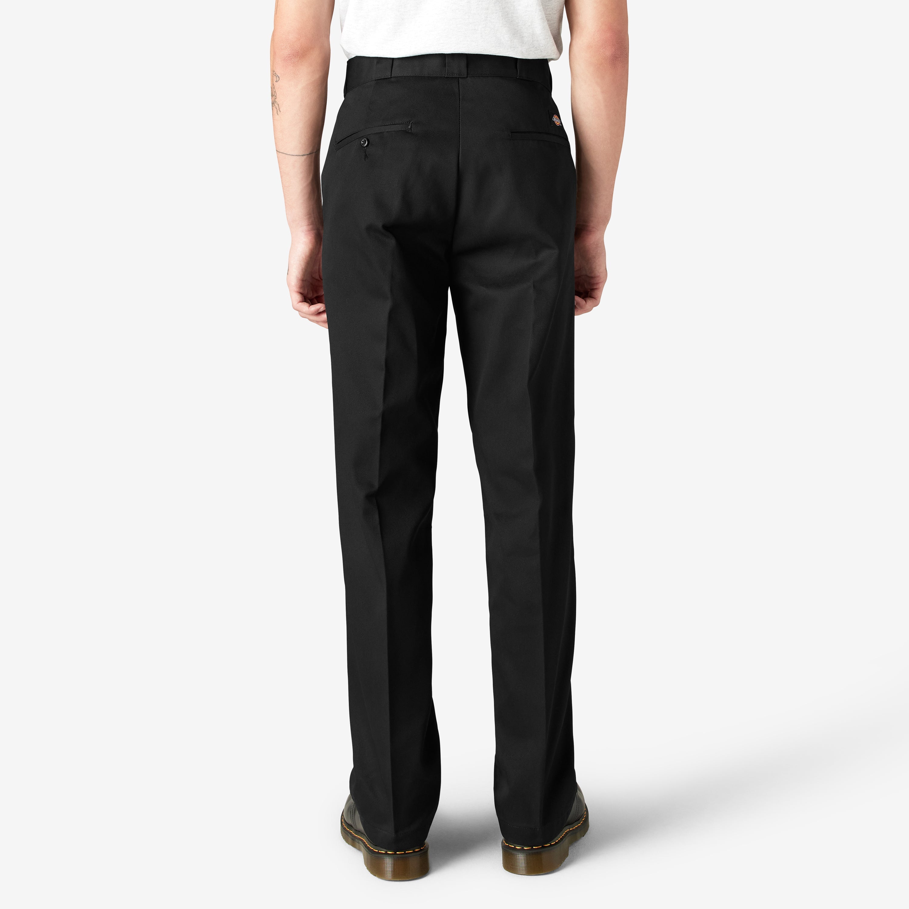 Person wearing 874 Original Work Pant Pants Black Pants, Rear view of wearer standing against neutral background, wearing