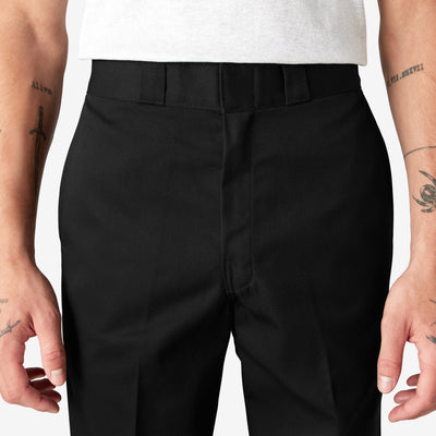 Person wearing 874 Original Work Pant Pants Black Pants, Wearer stands against neutral white backdrop, wearing black work