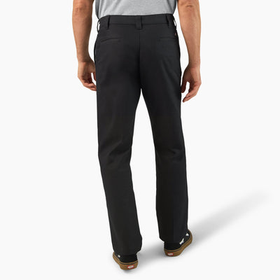 Person wearing 874 Pro Series Work Pant Pants Black Pants, Man wearing black work pants standing against neutral white
