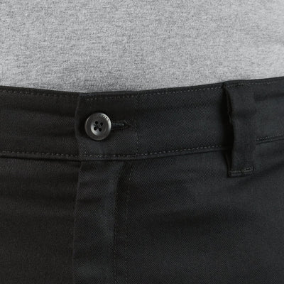 Close-up of 874 Pro Series Work Pant Pants Black Pants showing Metal button with four-hole design on black denim waistband -