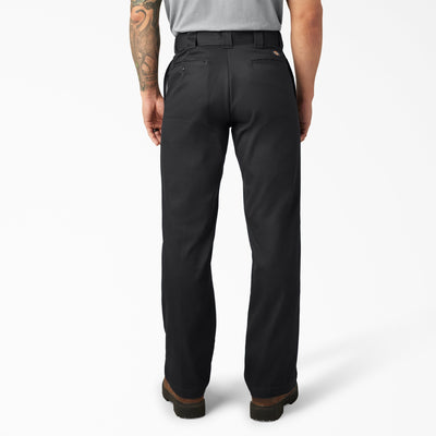 Person wearing 874f - Flex Work Pant Pants Dark Navy Pants, Black work pants with brown cuff detail shown from behind