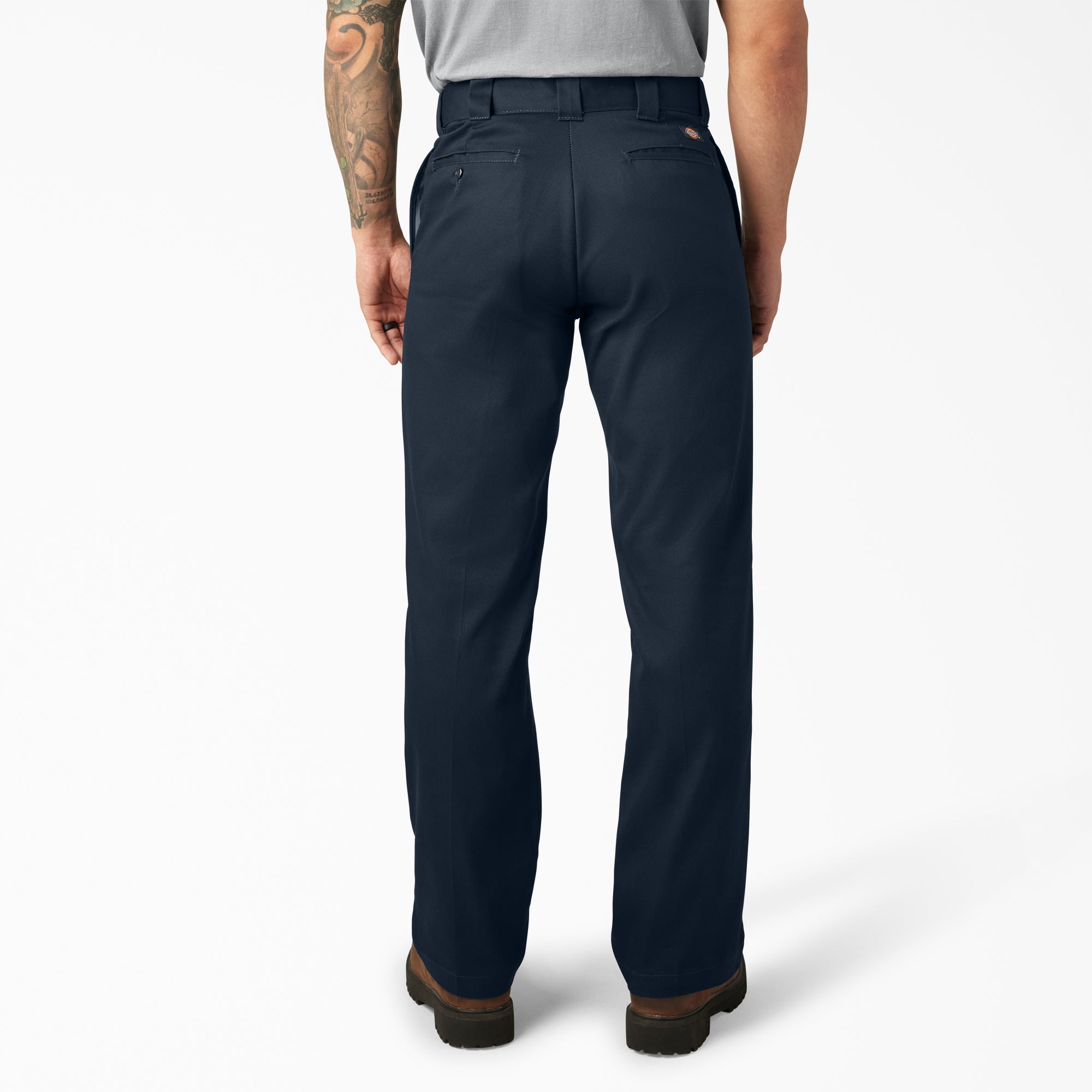 Person wearing 874f - Flex Work Pant Pants Dark Navy Pants, Rear view of wearer standing against white backdrop wearing dark