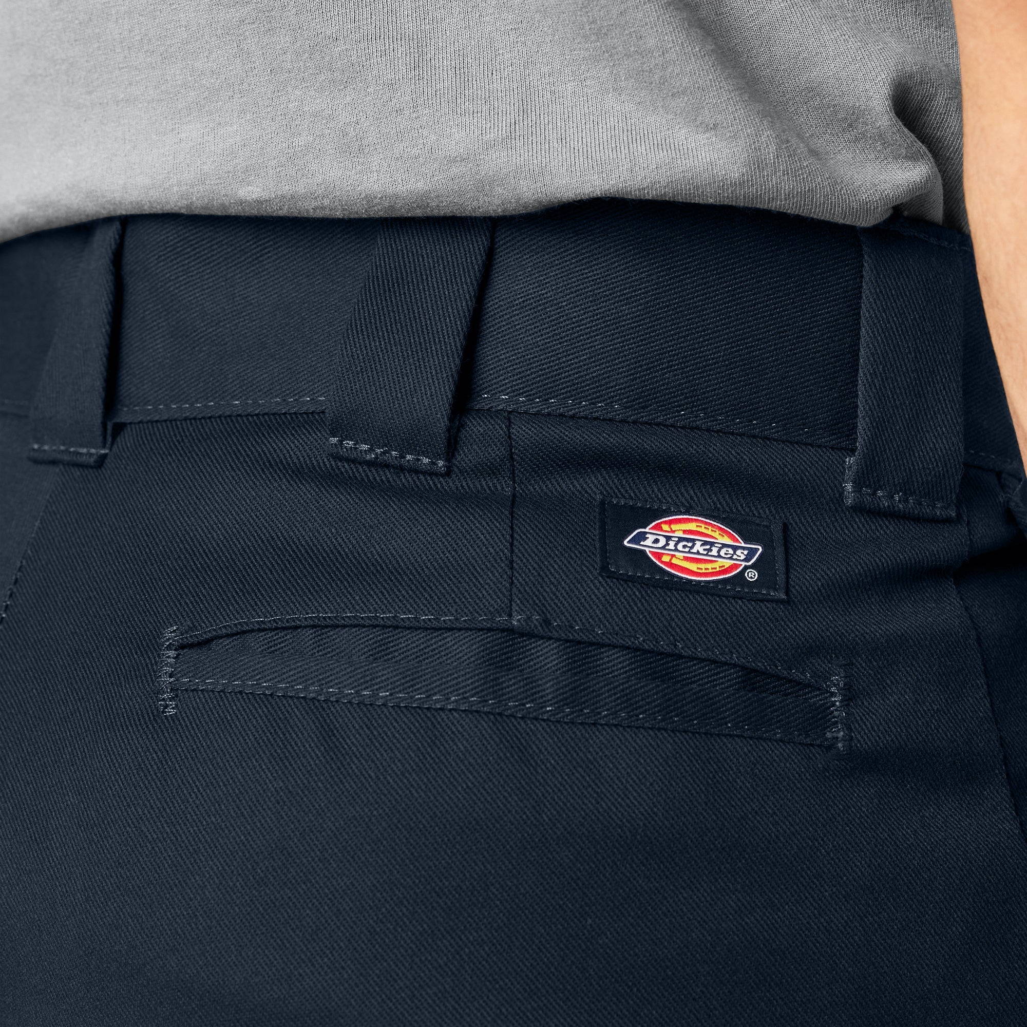 Close-up of 874f - Flex Work Pant Pants Dark Navy Pants showing Waistband label with red and yellow logo on dark navy twill