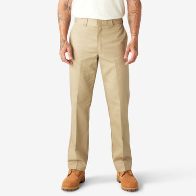 Person wearing 874f - Flex Work Pant Pants Dark Navy Pants, Tan work pants styled with cream t-shirt and tan work boots