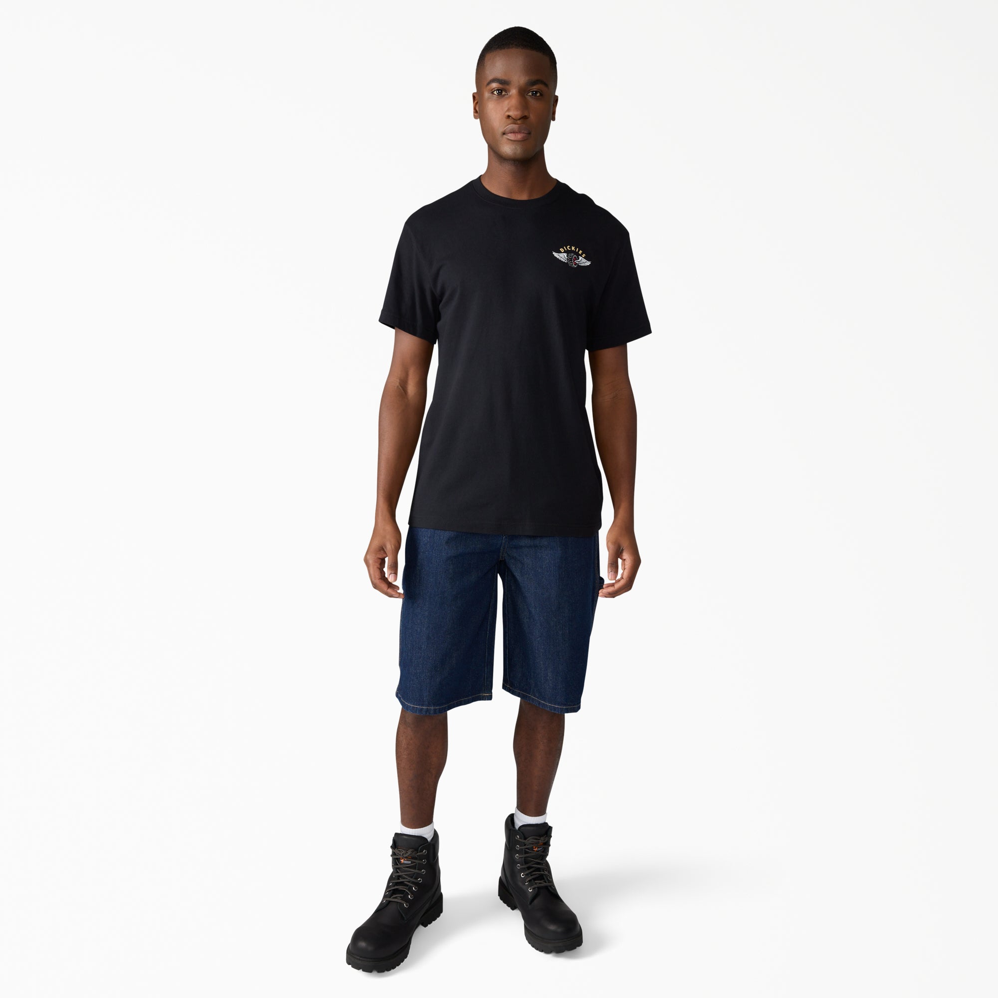 Person wearing A88a4 Denim Utility Short 13" Shorts Dark Wash Shorts, Plain white studio backdrop with neutral lighting and