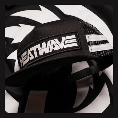 Close-up of Billboard Trucker Black Hat showing Black mesh trucker cap with white stripe and embroidered text on front panel