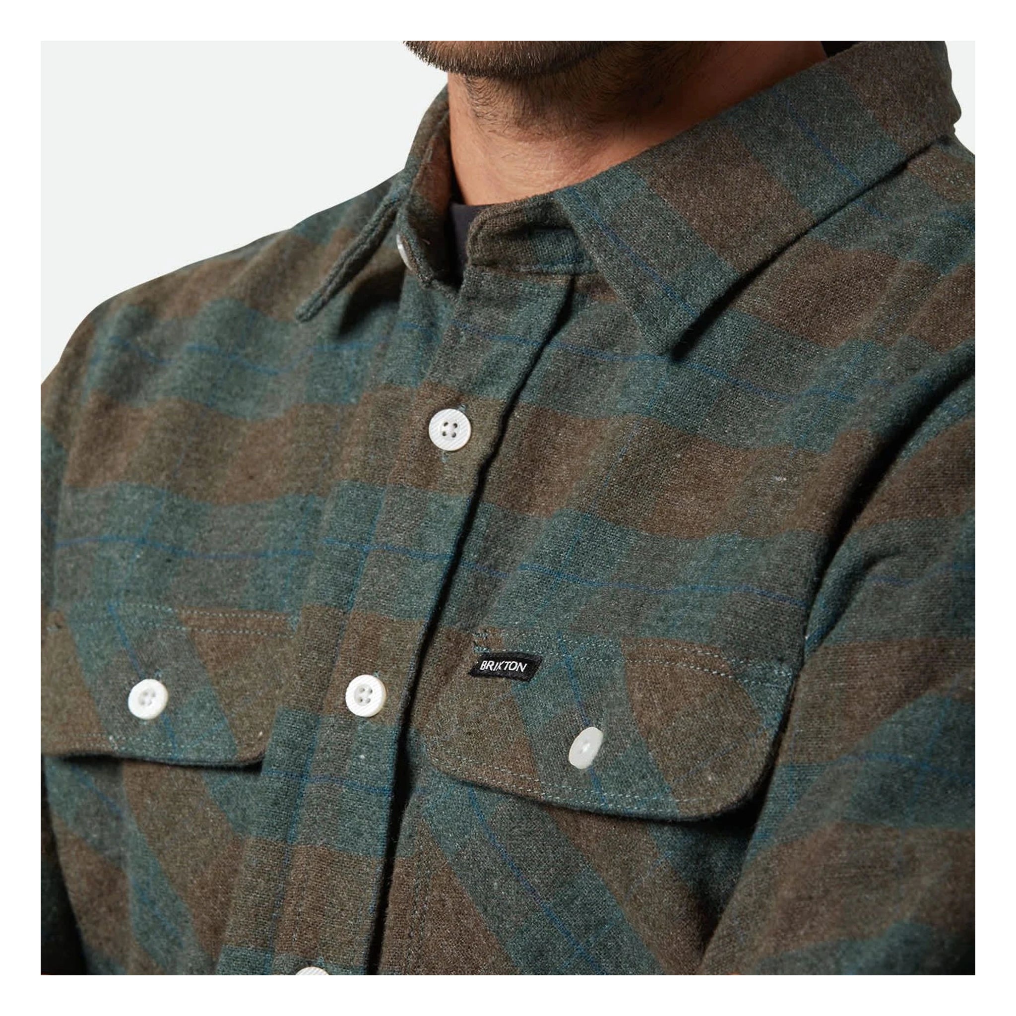 Person wearing Bowery Flannel Ocean L/S Woven L/S Woven, Man wearing plaid flannel shirt against neutral white backdrop -