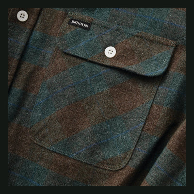 Close-up of Bowery Flannel Ocean L/S Woven L/S Woven showing White four-hole button on chest pocket, teal and brown plaid