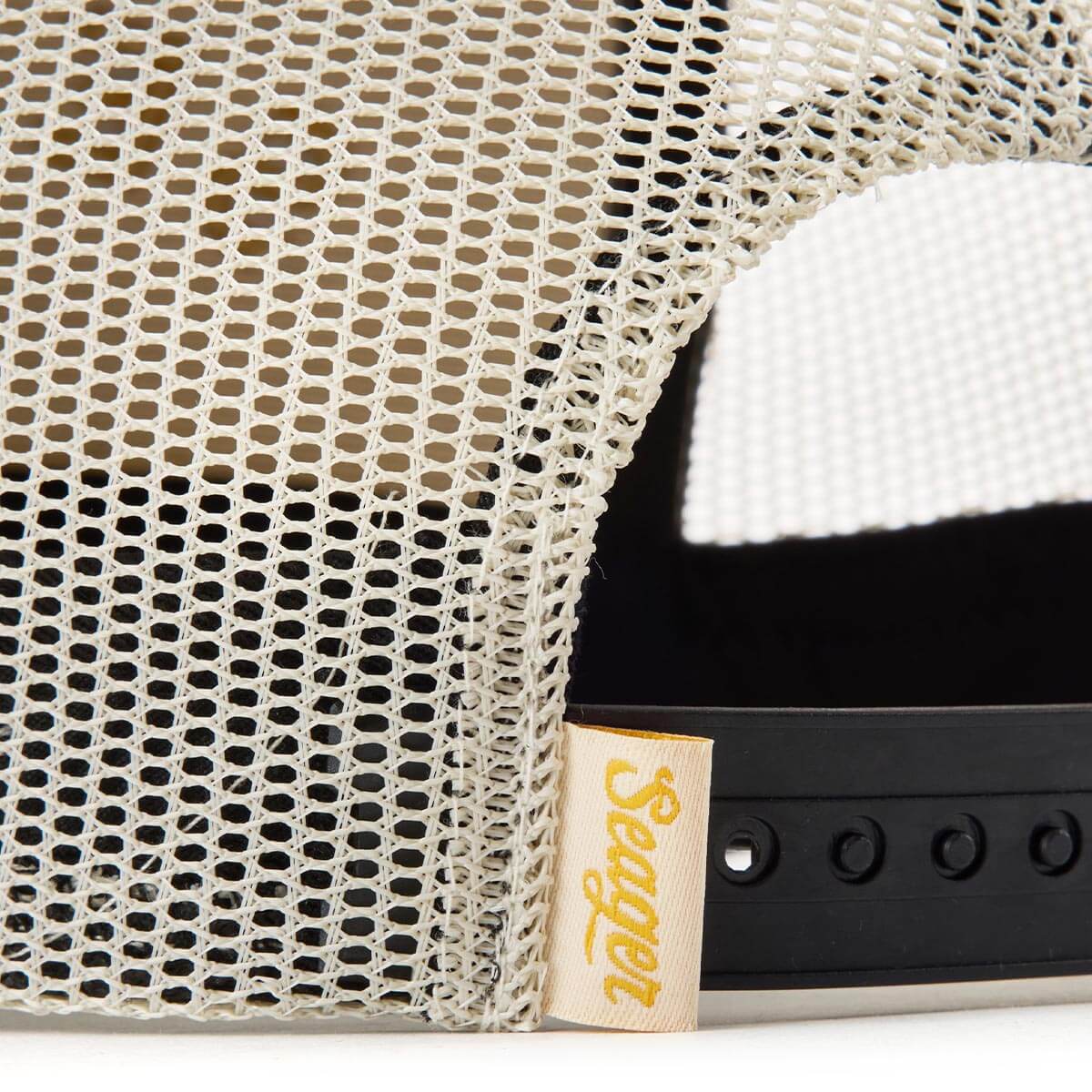 Close-up of Branded Snapback Hat Apparel Cream/Camo Apparel showing Cream mesh fabric with open weave pattern and yellow