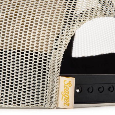 Close-up of Branded Snapback Hat Apparel Cream/Camo Apparel showing Cream mesh fabric with open weave pattern and yellow