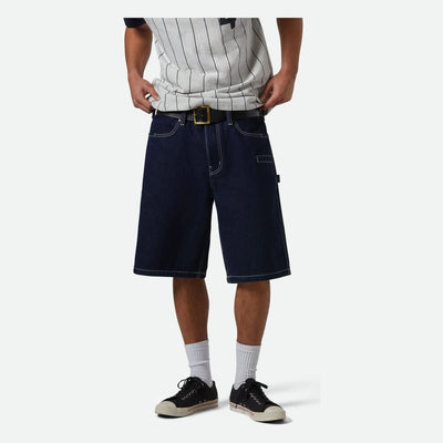 Person wearing Builders Carpenter Baggy Short Rinse Denim Shorts Shorts, Man standing against plain white background wearing