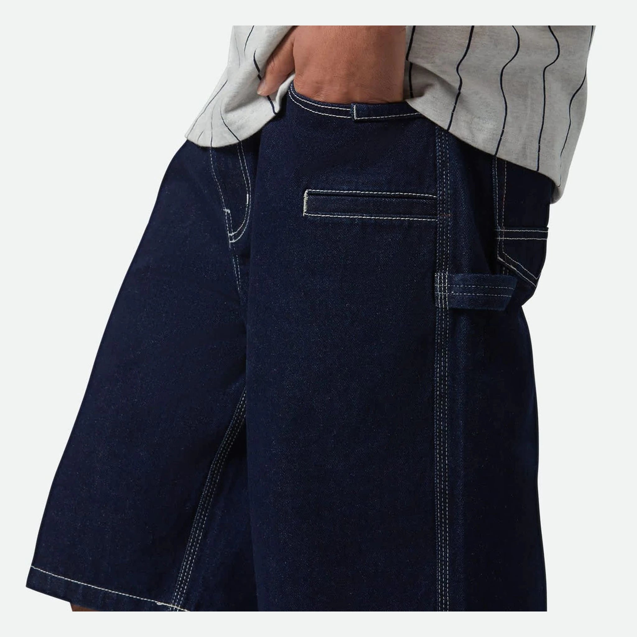 Person wearing Builders Carpenter Baggy Short Rinse Denim Shorts Shorts, Navy denim shorts worn with grey pinstriped shirt