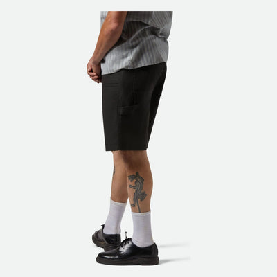 Person wearing Builders Carpenter Baggy Short Shorts Washed Black Shorts, Man wearing black shorts and white socks against