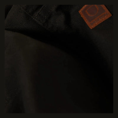 Care label on Builders Carpenter Baggy Short Shorts Washed Black Shorts showing Rust leather patch with embossed circular