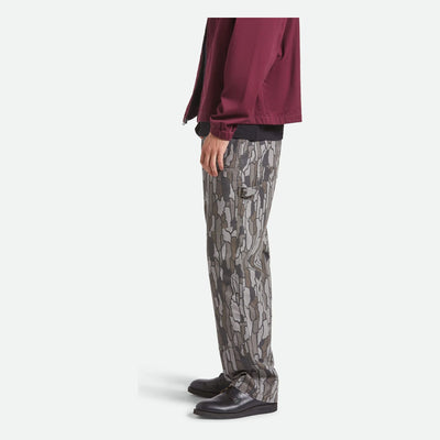 Person wearing Builders Carpenter Pant Pants Washed Black Pants, Gray and black camouflage print pants worn with burgundy
