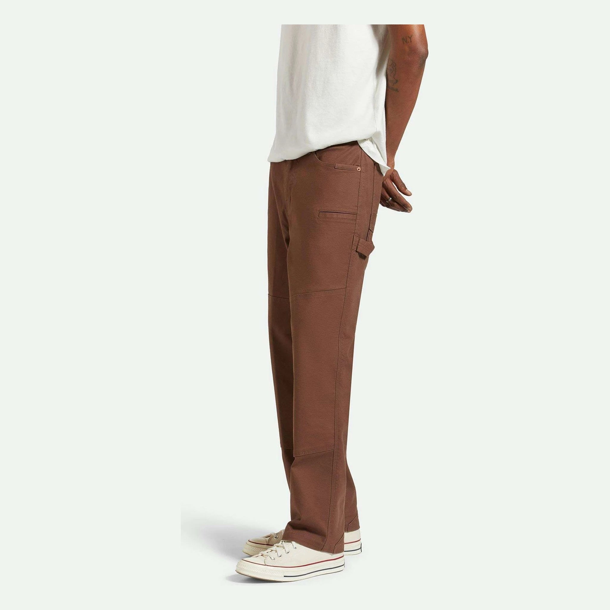 Person wearing Builders Carpenter Pant Pants Washed Black Pants, Neutral studio setting with plain white background -