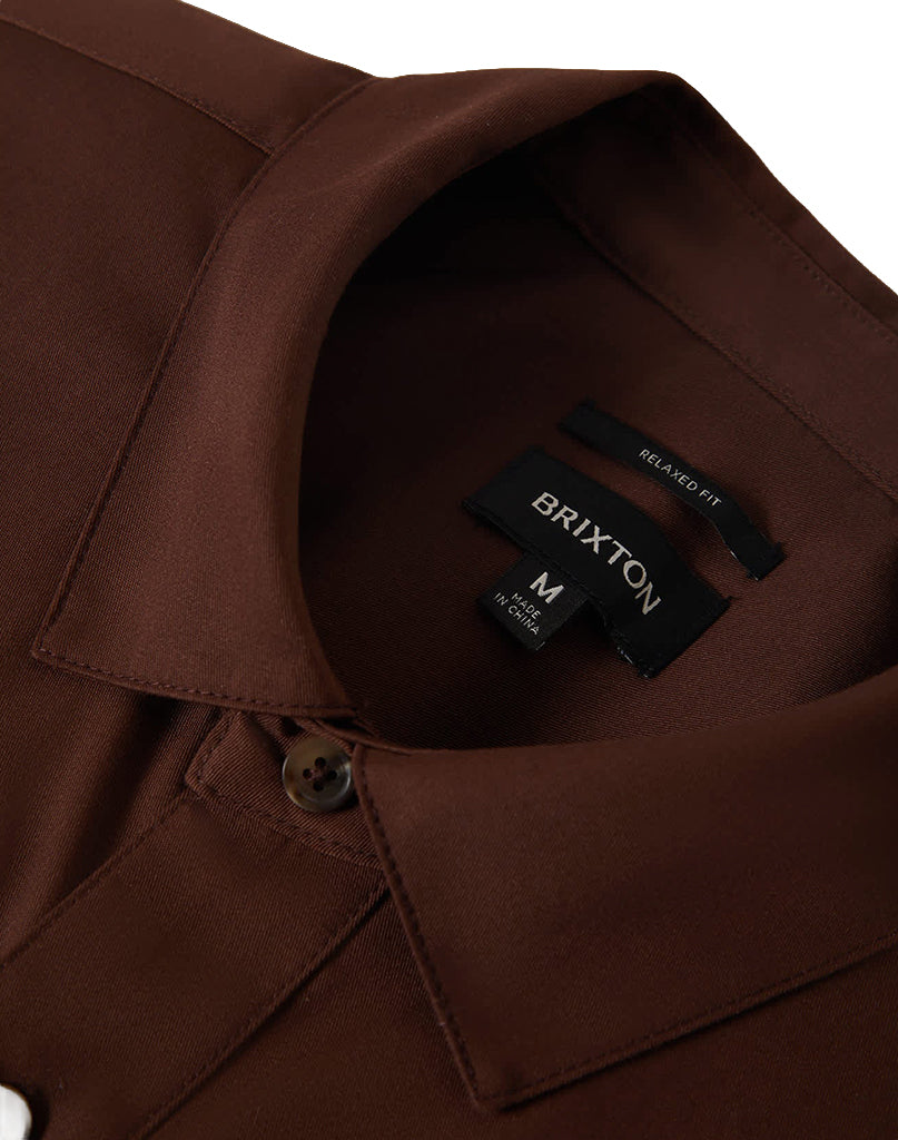 Care label on Builders Olson S/s Woven Apparel Chocolate Apparel showing Black label with white text reading "BRIXTON" and