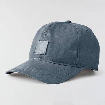 Close-up of Canvas Cap Brown Hat showing Slate blue canvas with woven texture and white woven label patch on crown -