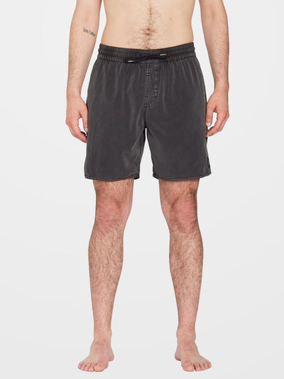 Person wearing Center Trunk 17" Boardshorts Black Boardshorts, Man standing shirtless against neutral white background -