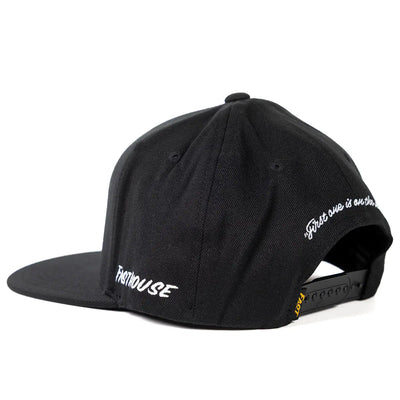 Close-up of Cold Ones Black Hat showing Black baseball cap with white cursive script on back and side panels, snapback