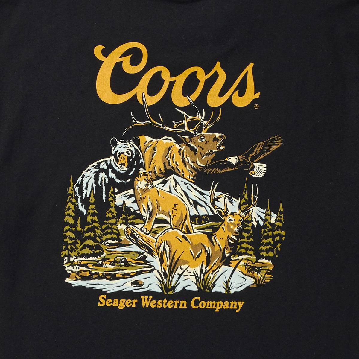 Close-up of Coors Banquet Preserve Black Tee showing Coors script in gold with wildlife scene below, featuring bear, elk,