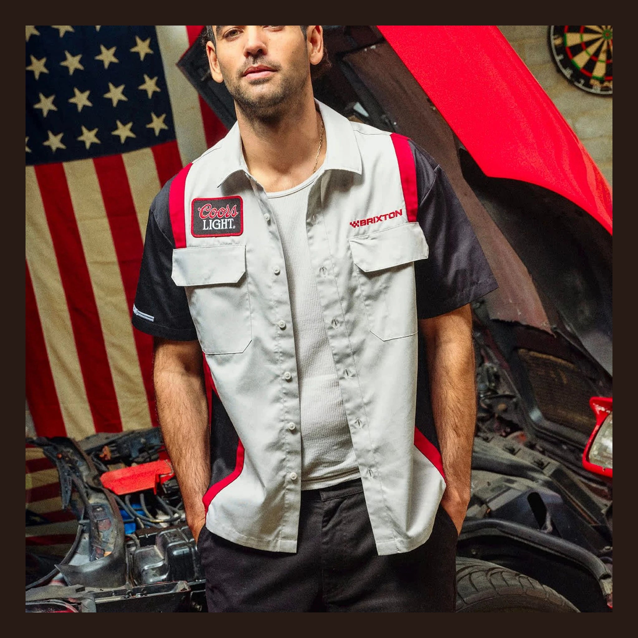 Person wearing Coors Light Shake Down S/S Woven Silver/black S/S Woven, Garage setting with American flag and red car hood