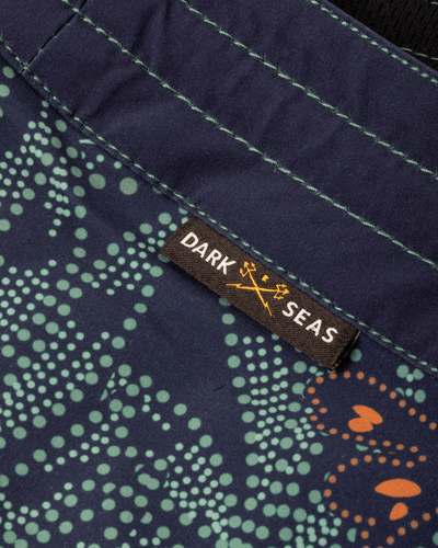 Care label on Deepwater Boardshort Boardshorts Navy Boardshorts showing Brown woven label with white and gold text and