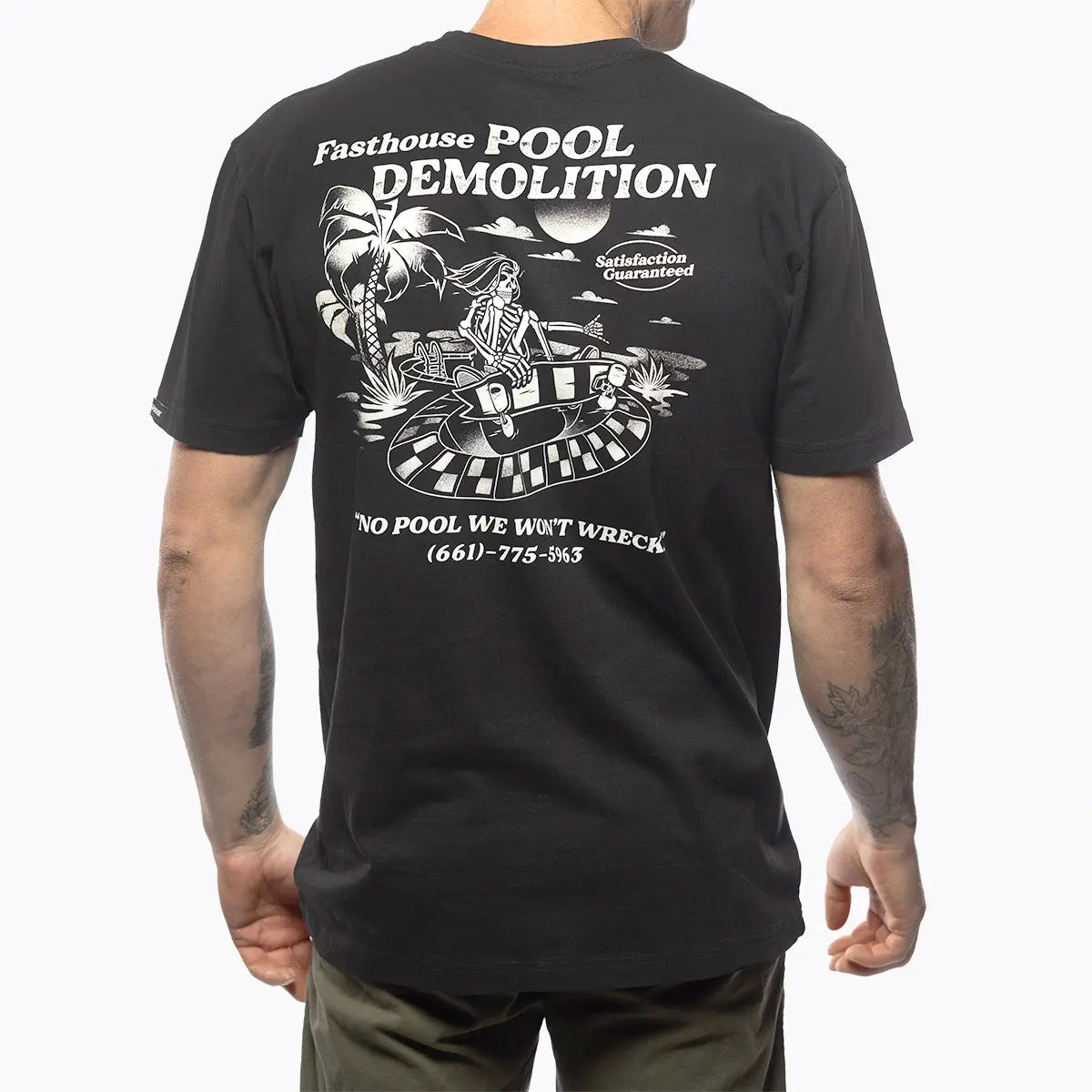 Person wearing Demolition Black Tee, Man wearing black tee standing against white studio background - Slowride Supply