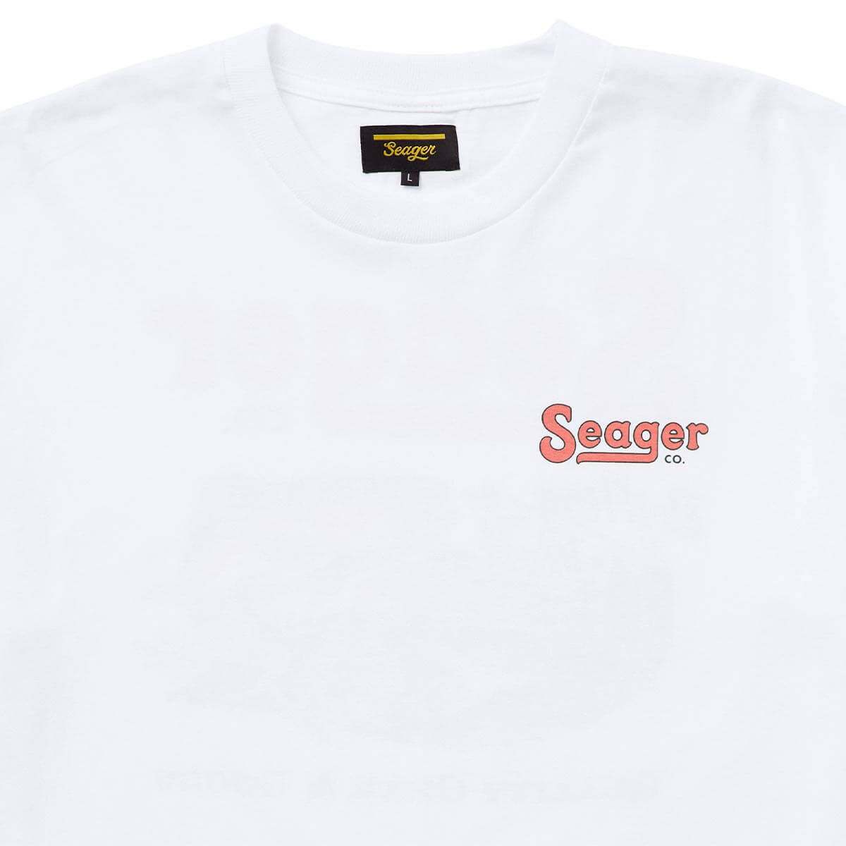 Close-up of Drifting the West White Tee showing Black woven label with gold script text and size L tag sewn at neckline -
