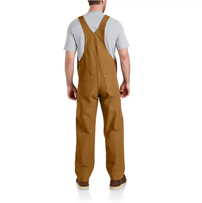 Person wearing Duck Bib Overalls Black Overalls, Worn over a gray t-shirt in a neutral studio setting - Slowride Supply