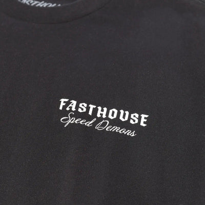 Close-up of Fallen Black Tee showing White embroidered text reading "Fasthouse" with script subtitle "Speed Demons" on black