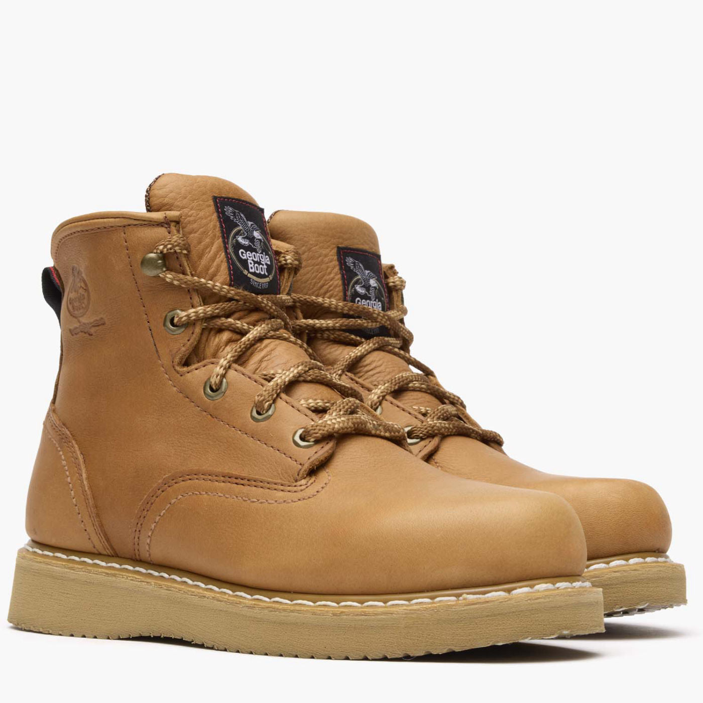 Back of G6152 6" Wedge Barracuda Boots Gold Boots, Tan leather back with embossed logo and navy brand label with white