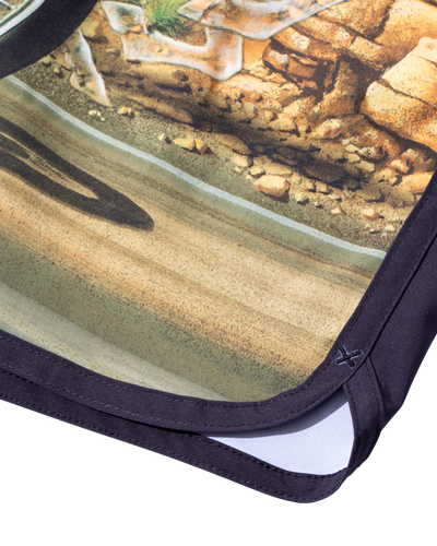 Close-up of Ghost Rider Boardshort Boardshorts Black Boardshorts showing Black binding and hem stitching with printed dirt