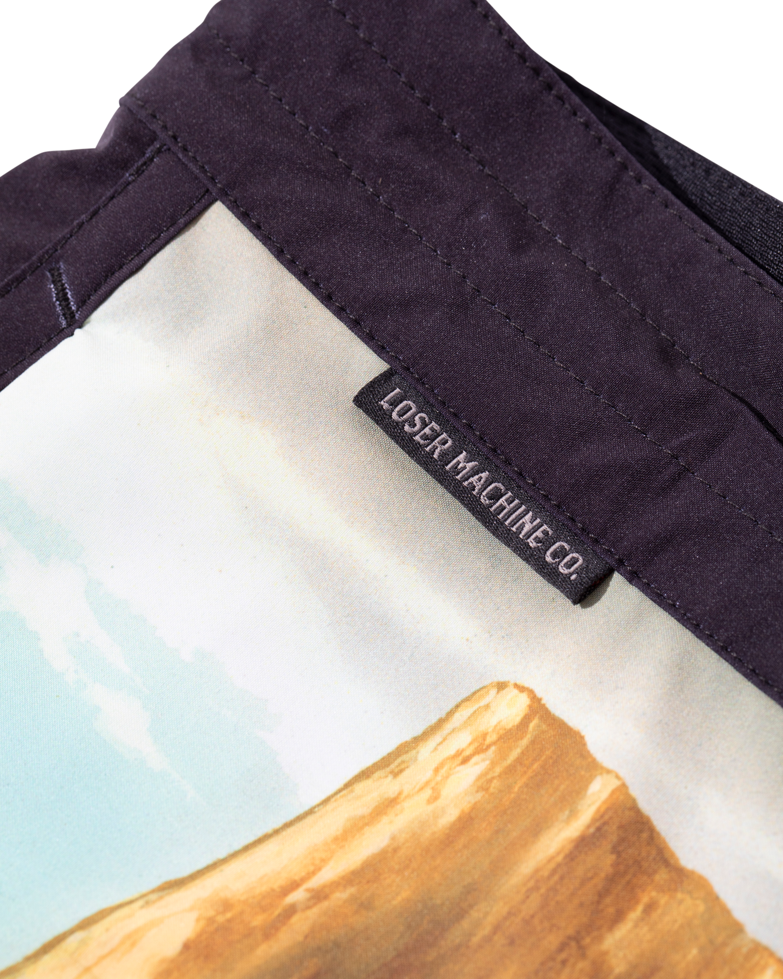 Close-up of Ghost Rider Boardshort Boardshorts Black Boardshorts showing Black woven label sewn inside waistband with