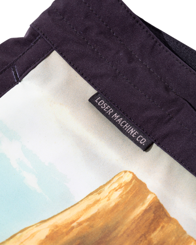 Close-up of Ghost Rider Boardshort Boardshorts Black Boardshorts showing Black woven label sewn inside waistband with