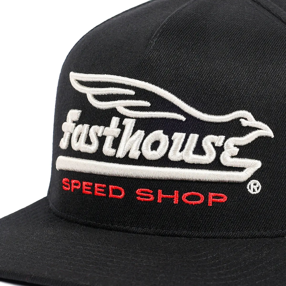 Close-up of Gilmore Black Hat showing White embroidered wing graphic above cream script text and red speed shop lettering on