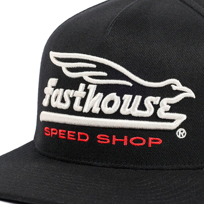 Close-up of Gilmore Black Hat showing White embroidered wing graphic above cream script text and red speed shop lettering on