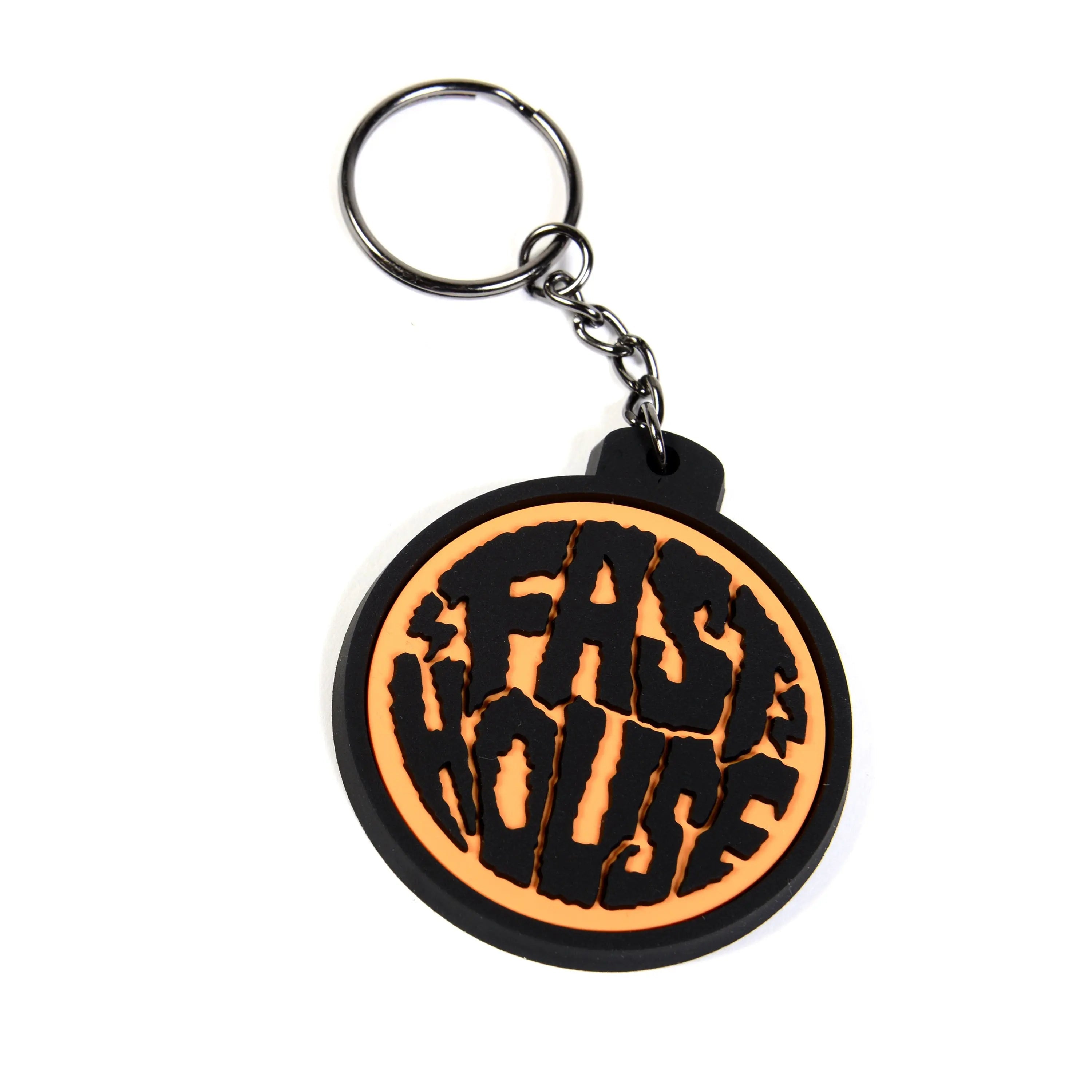 Back of Grime Keychain Accessory Gold Accessory, Black rubber circular pendant with orange crackle background and black