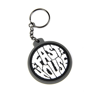 Close-up of Grime Keychain Accessory Gold Accessory showing Round rubber keychain with gray and black rim, white face