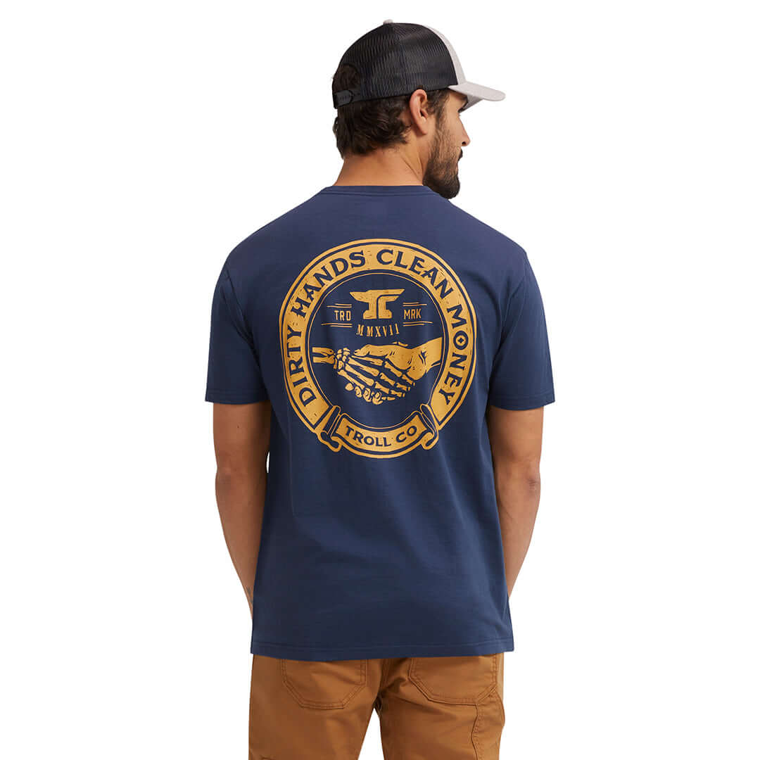 Person wearing Haggler Black Tee, Man wearing navy tee with gold circular back graphic, standing against white background -