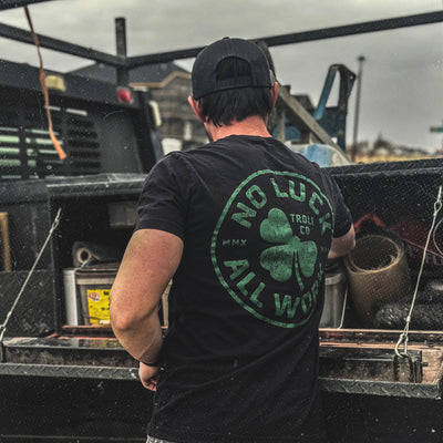 Back of Hardluck Black Tee, Black with green circular clover graphic and text reading "Troy Co" and "MMX - Slowride Supply