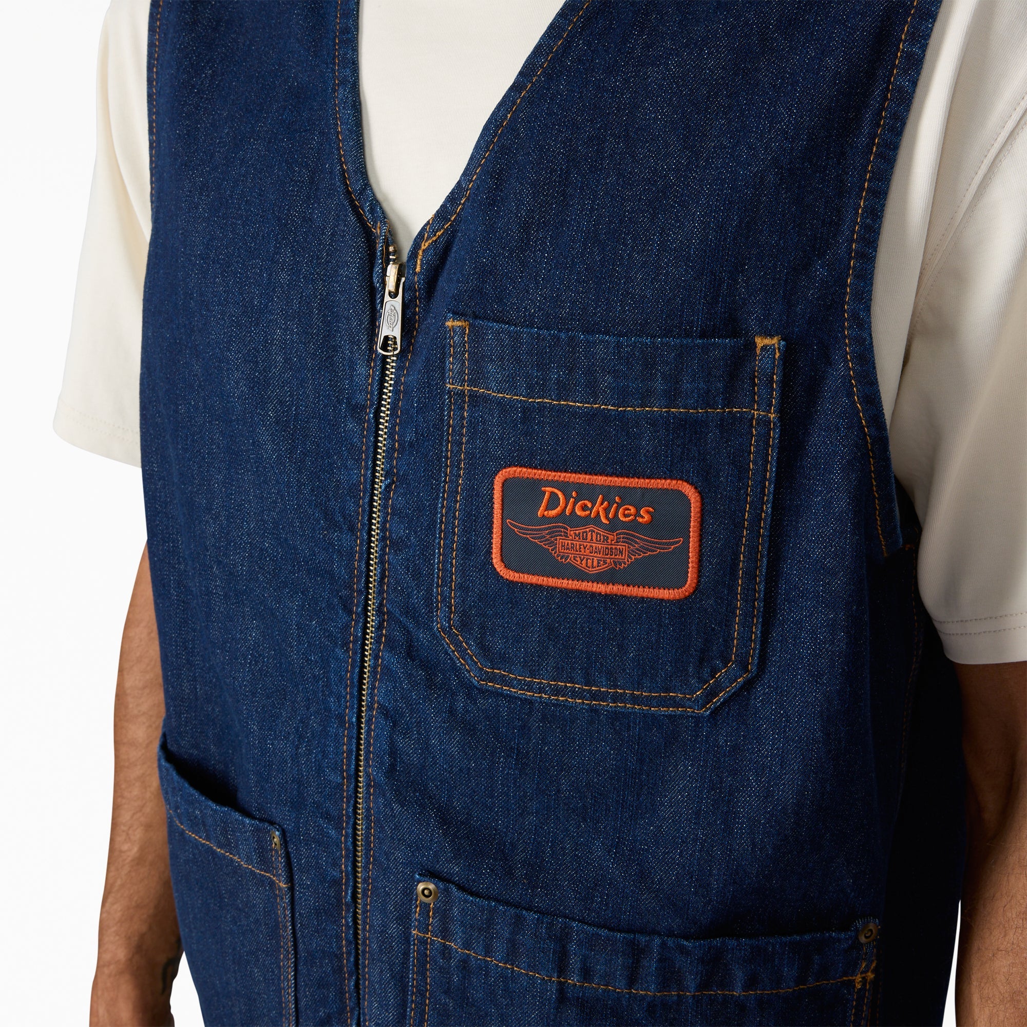 Close-up of Hdxdickies Denim Lined Vest RNB Vest Vest showing Orange embroidered patch on chest pocket with winged graphic