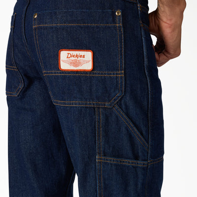 Close-up of Hdxdickies Denim Pant RNB Pants Pants showing Orange and white woven label patch with winged graphic on front
