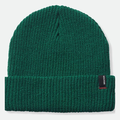Close-up of Heist Mustard Beanie showing Forest green ribbed knit with tonal texture throughout, brand label at fold cuff -