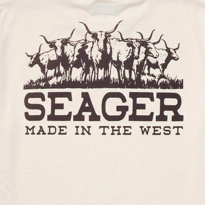 Close-up of Herd Vintage White Tee showing Brown longhorn cattle herd graphic with grass line and bold typeface below -