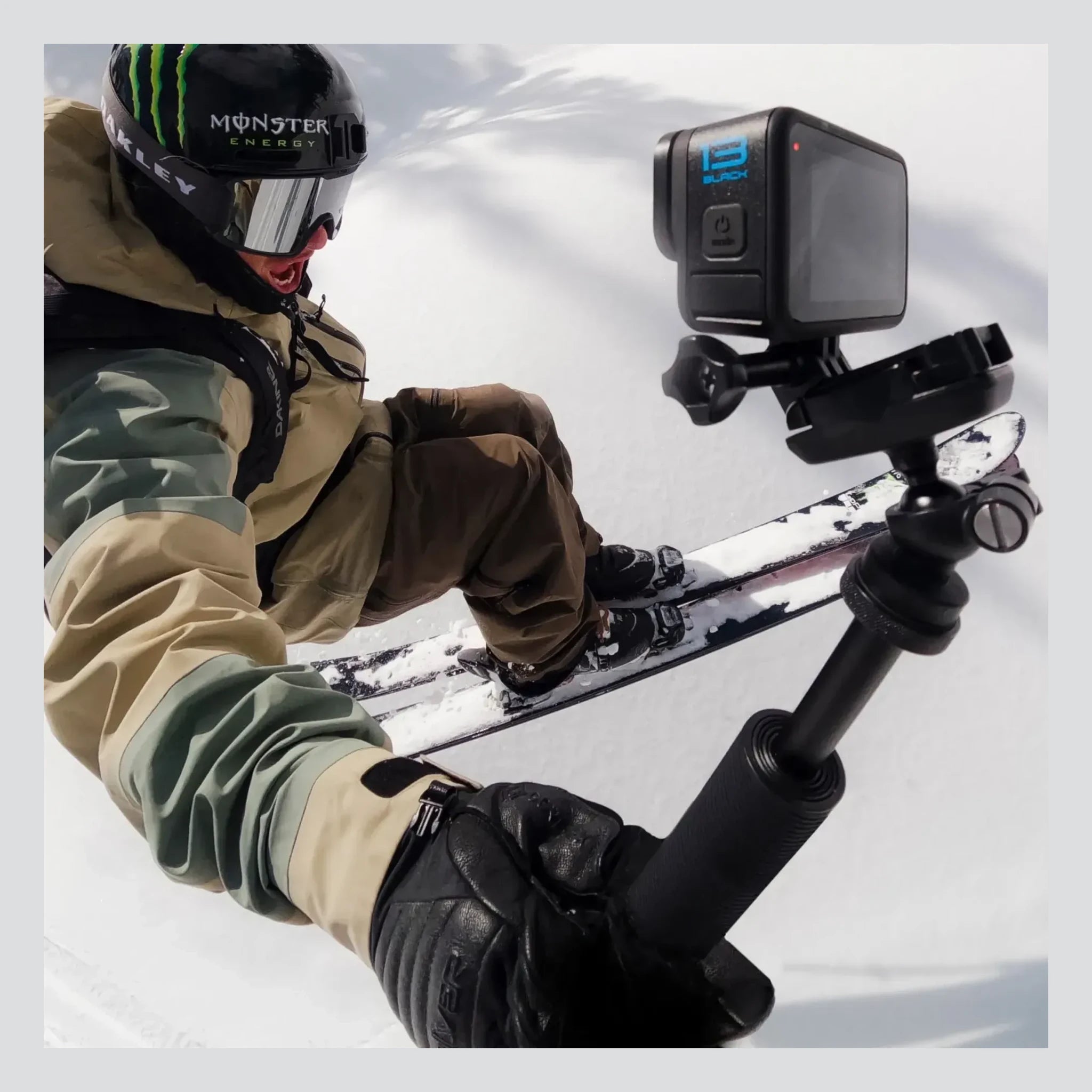 Person wearing Hero 13 Camera Camera, Skier in mid-air on snow-covered mountain slope - Slowride Supply