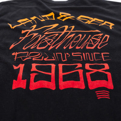 Close-up of Horizon Black Tee showing Print texture showing layered orange to red gradient lettering with racing-themed