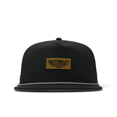 Hydro Coronado Brick front view, Black snapback with gold rectangular label patch, white rope trim on bill, Black Hat -