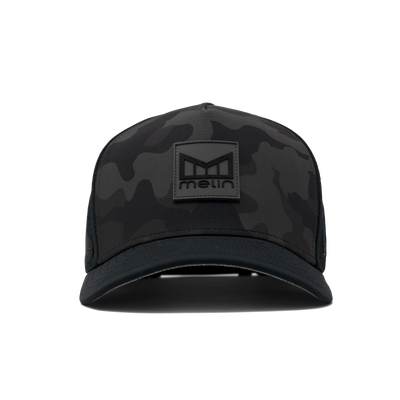 Close-up of Hydro Odyssey Stacked Black Camo Hat showing Black camouflage crown with tonal rubber logo patch and solid black