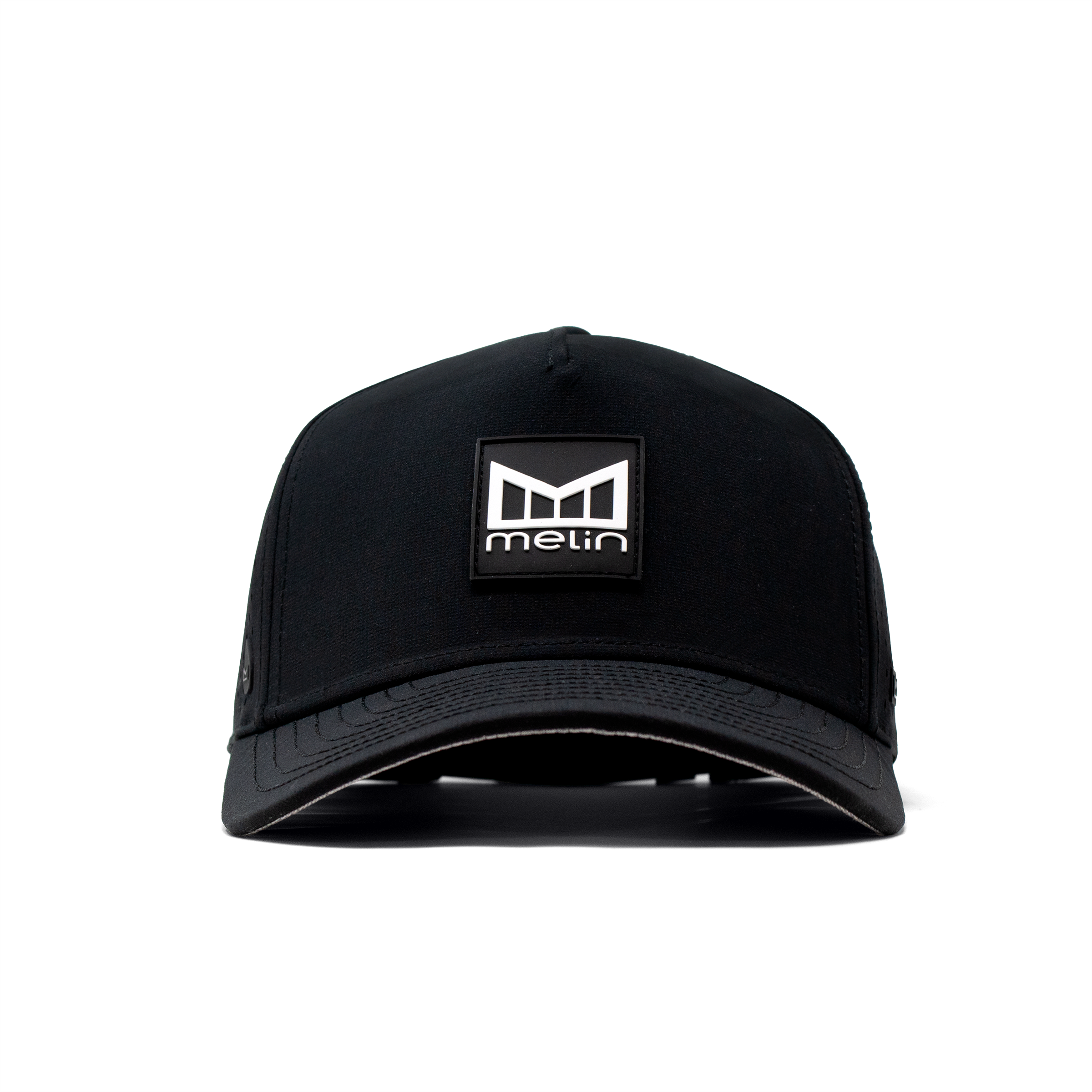 Close-up of Hydro Odyssey Stacked Black Camo Hat showing Black cap with woven logo patch featuring geometric shield and text